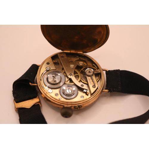 236 - Ladies 9ct Gold Edwardian wristwatch with numeral dial on black fabric strap. 32mm in Diameter