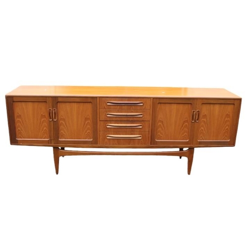 311 - G Plan Mid Century Teak Low sideboard of 4 drawers flanked by double cupboards with cup handles and ... 