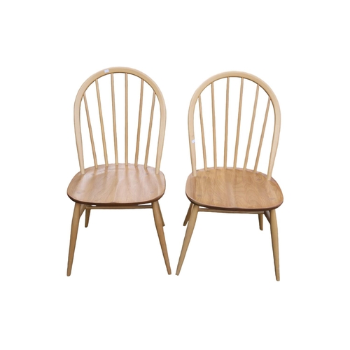 322 - Pair of Ercol of Windsor Blonde Elm dining chairs on tapering legs, with gold applied button