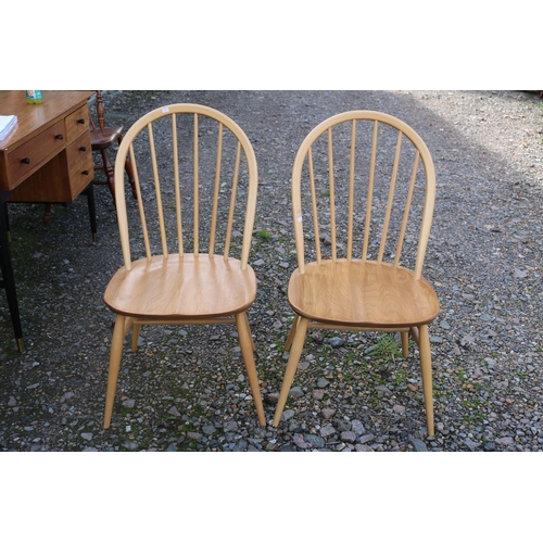 322 - Pair of Ercol of Windsor Blonde Elm dining chairs on tapering legs, with gold applied button