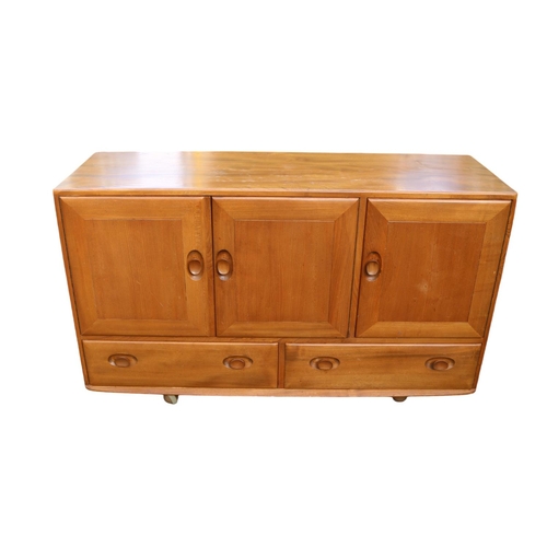 336 - Ercol Windsor Mid Century Elm Sideboard of 3 cupboards over 2 drawers on casters.  129cm x 71cm x 11... 