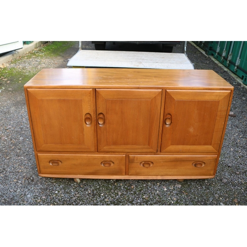 336 - Ercol Windsor Mid Century Elm Sideboard of 3 cupboards over 2 drawers on casters.  129cm x 71cm x 11... 