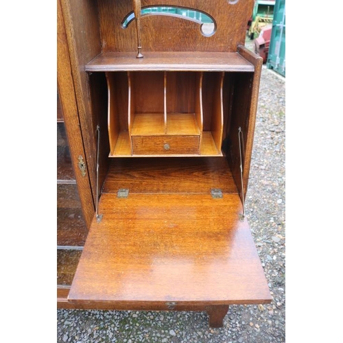 341 - Art Nouveau Oak fall front bureau bookcase with glazed front and brass handles, mirror to top with c... 