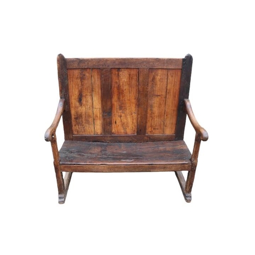 355 - 18thC Elm vernacular settle with high raised panel back and curved elbows. 122cm in Width by 56cm in... 