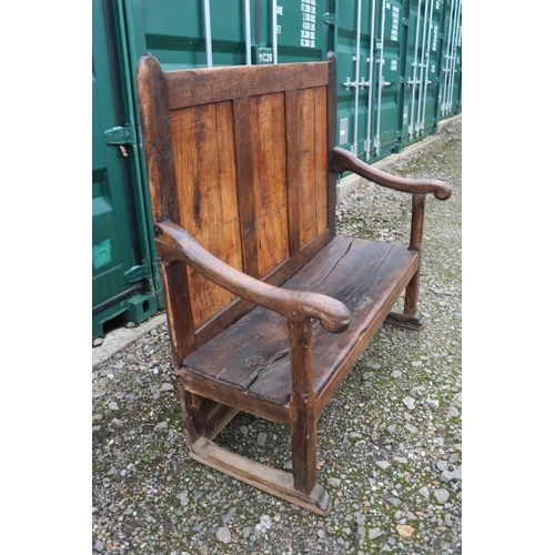 355 - 18thC Elm vernacular settle with high raised panel back and curved elbows. 122cm in Width by 56cm in... 