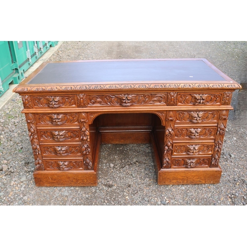 364 - 19thC Oak Heavily carved Greenman pedestal desk with Eleven drawers, carved panel sides and front an... 