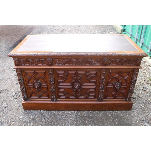 364 - 19thC Oak Heavily carved Greenman pedestal desk with Eleven drawers, carved panel sides and front an... 