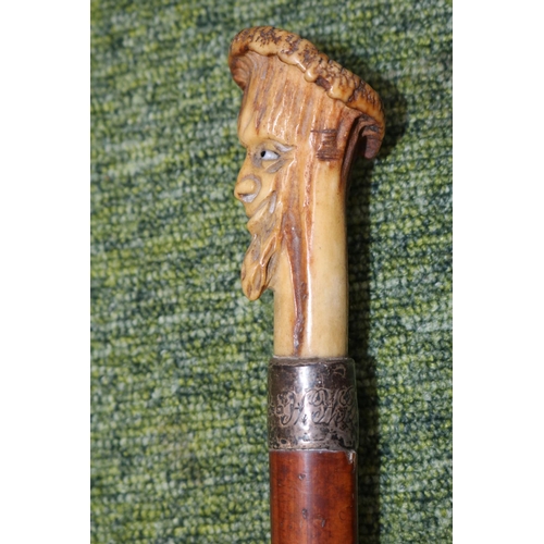 55 - 19thC Antler topped walking Cane with carved bearded face over Silver Collar and tapering fruitwood ... 