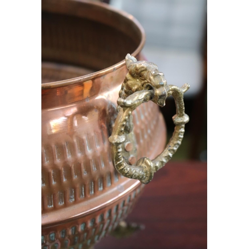 71 - Copper Hammered Urn planter with Brass Griffin handles over scroll brass feet. 26cm in Height