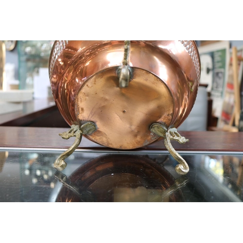 71 - Copper Hammered Urn planter with Brass Griffin handles over scroll brass feet. 26cm in Height