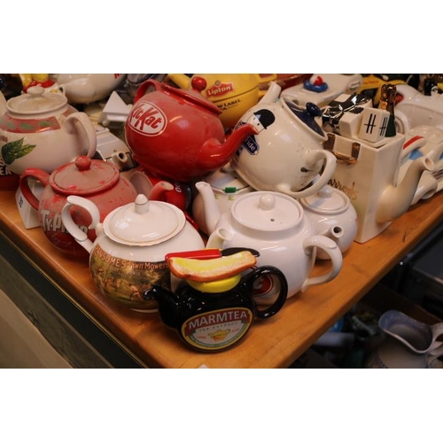 212 - Large collection of Novelty Teapots to include Marmite, Kit Kat, Ransomes Lawnmowers, JCB, Black and... 