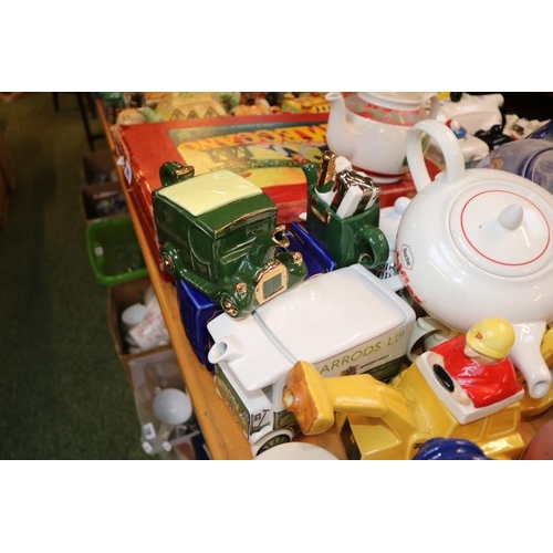 212 - Large collection of Novelty Teapots to include Marmite, Kit Kat, Ransomes Lawnmowers, JCB, Black and... 