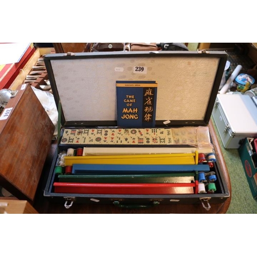 239 - Cased set of Mah Jong to include counters, stands, Game book etc.