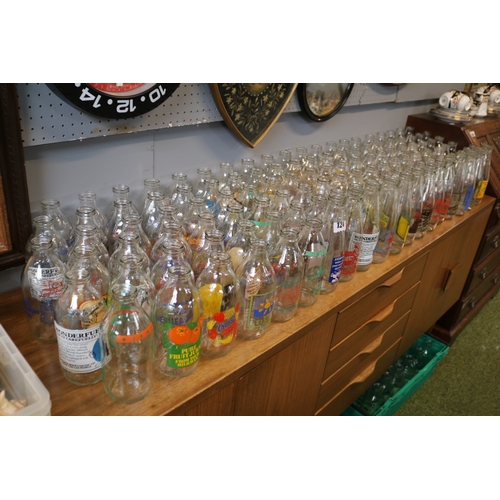124 - Large collection of Advertising glass Milk Bottles to include Kelloggs, Cadburys, Crusha etc.