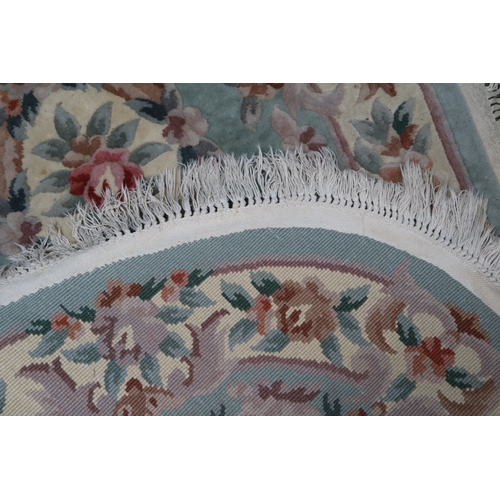 45 - Chinese floral decorated oval rug with tassel ends 170cm in Length
