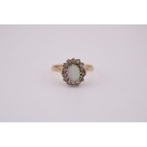 487 - Good quality Ladies 18ct Gold Oval Opal and Diamond cluster ring. Size M. 2.1g total weight