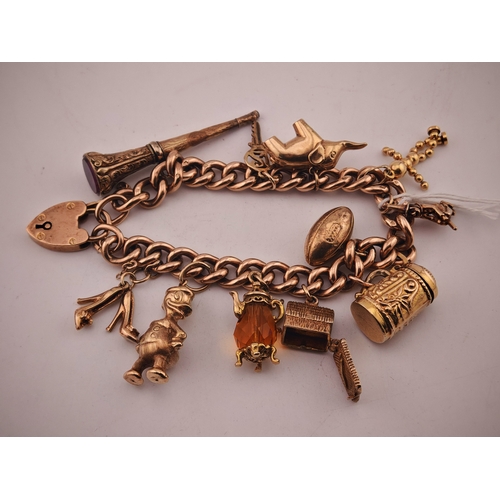579 - Ladies 9ct Gold Charm bracelet with assorted charms to include Daffy Duck, Beer Stein, Propelling Pe... 