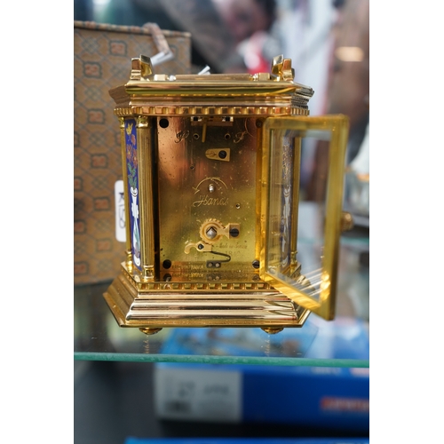 29 - Good Quality Brass Cased Carriage clock with Porcelain floral panels and Roman numeral face. 14cm in... 