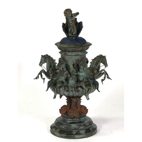 2 - A bronzed centre piece decorated with hippocampus and cherubs, surmounted with a further cherub with... 