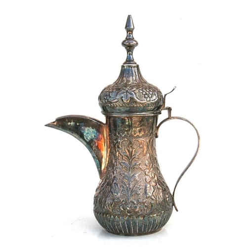 76 - A Turkish/Islamic white metal (?) dallah coffee pot with embossed foliate decoration. 29cm (11.5 ins... 