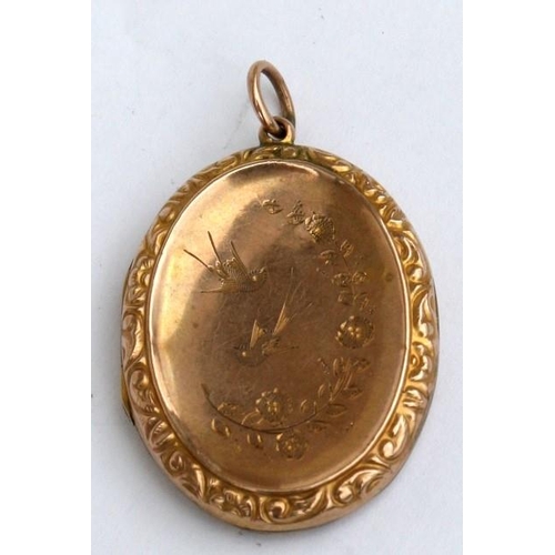 88 - A Victorian yellow metal oval locket engraved with birds and flowers. 3.5cm (1.3 ins) high