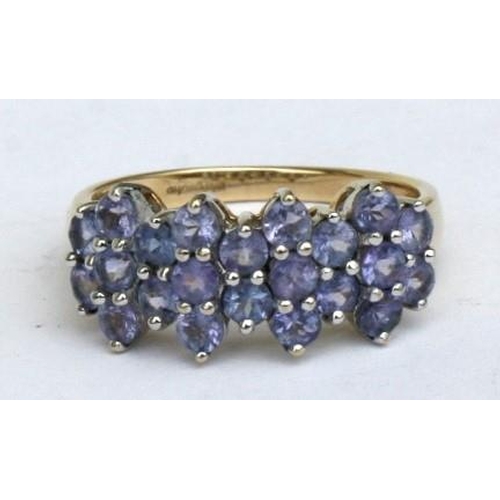 93 - A 9ct gold dress ring set with twenty two pale purple stones. Approx UK size R