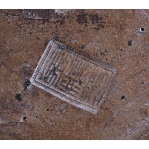 443 - A Chinese Shiwan pottery figure in the form of an emaciated robed figure holding his shoe, impressed... 