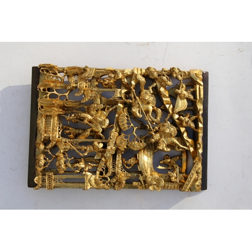 442 - A large Chinese pierced giltwood temple panel decorated with warriors in a landscape, 30 by 46cms (1... 