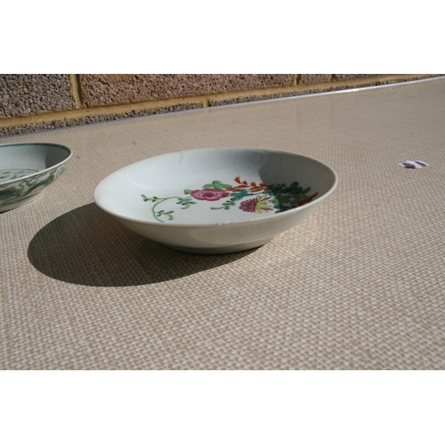 444 - A pair of Chinese famille rose saucer dishes decorated with flowers, 15cms (6ins) diameter; together... 