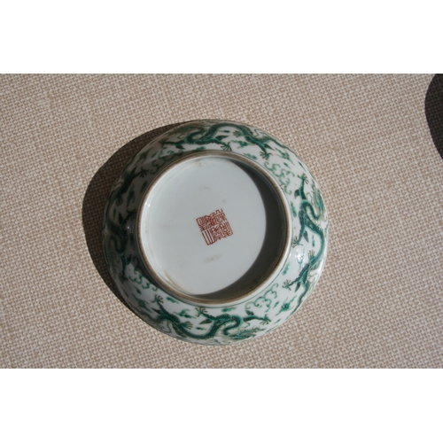 444 - A pair of Chinese famille rose saucer dishes decorated with flowers, 15cms (6ins) diameter; together... 