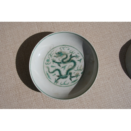 444 - A pair of Chinese famille rose saucer dishes decorated with flowers, 15cms (6ins) diameter; together... 