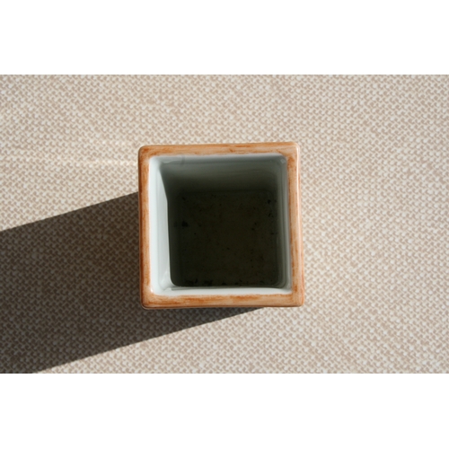 445 - A Chinese square form brush pot decorated with precious objects, ten character mark to the underside... 