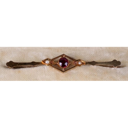 128 - A 15ct gold garnet and pearl bar brooch, boxed.