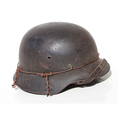 173 - A WW2 Third Reich helmet with liner and chin strap. Marked inside SE66 & 4704