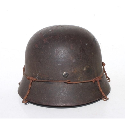 173 - A WW2 Third Reich helmet with liner and chin strap. Marked inside SE66 & 4704