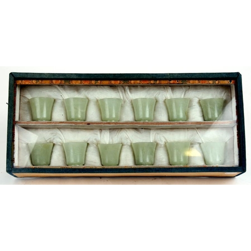 328 - A cased set of twelve Chinese jade like cups with D & S Howlett collection label to the undersid... 