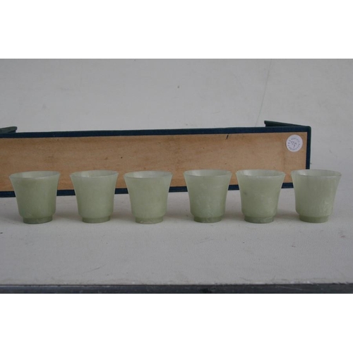 328 - A cased set of twelve Chinese jade like cups with D & S Howlett collection label to the undersid... 