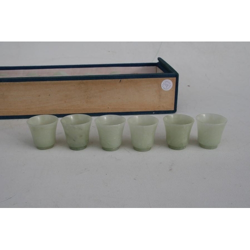 328 - A cased set of twelve Chinese jade like cups with D & S Howlett collection label to the undersid... 