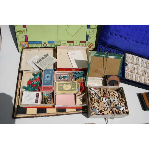 79 - A group of vintage board games; together with a boxed soapstone chess set.