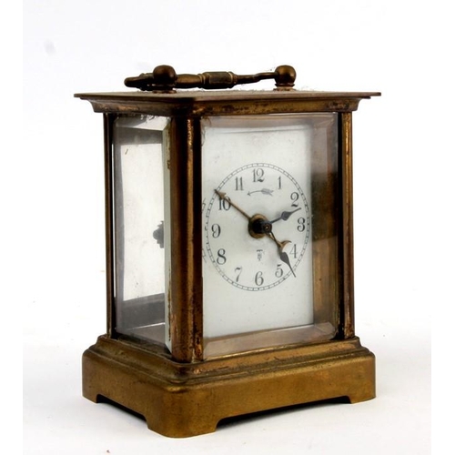 128 - A brass cased carriage alarm clock, the white enamel dial with Arabic numerals, 10cm (4ins) high.