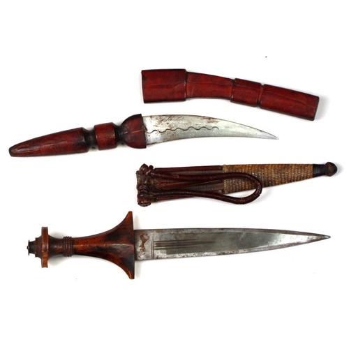 248 - Two African tribal daggers in leather sheaths. Blade lengths of 15cms (5.875ins) and 22cms (8.625ins... 