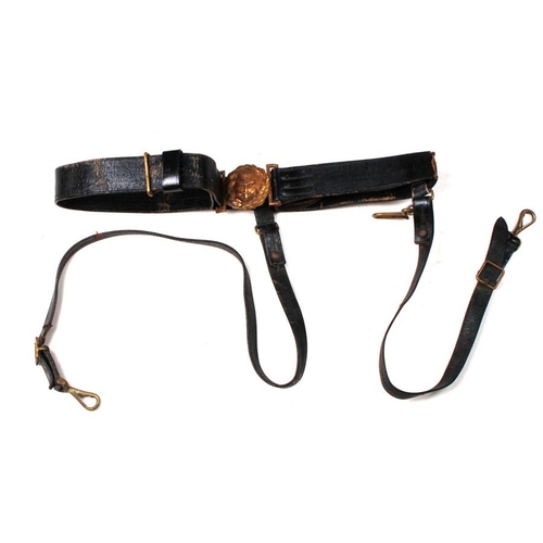 284 - An early 20th century British Royal Navy black leather sword belt with hanging straps and brass fitt... 