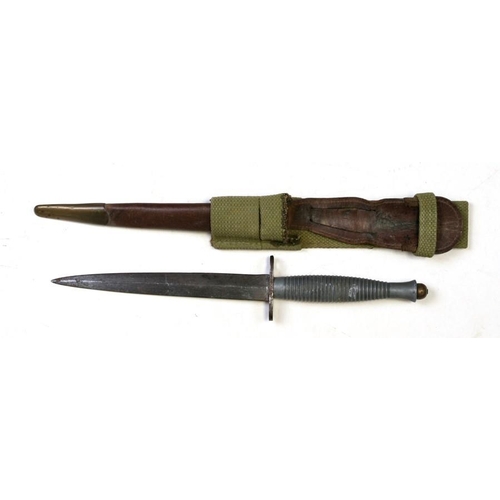 305 - A Fairbairn-Sykes style fighting knife in leathered scabbard