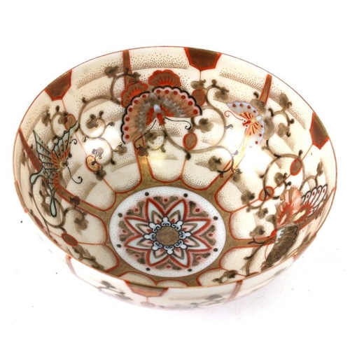 315 - A Japanese Kutani bowl decorated with butterflies and foliate scrolls, 15cms (6ins) wide.