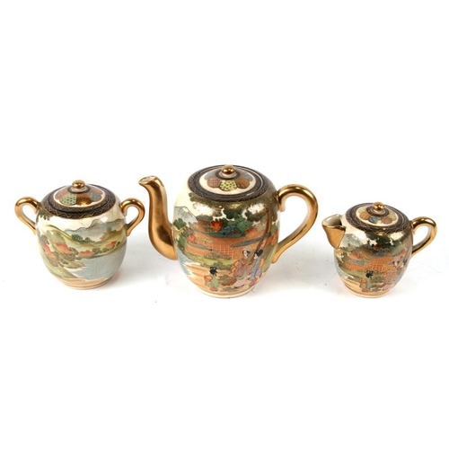 316 - A late 19th / early 20th century Japanese Satsuma three-piece teaset decorated with figures in a lan... 