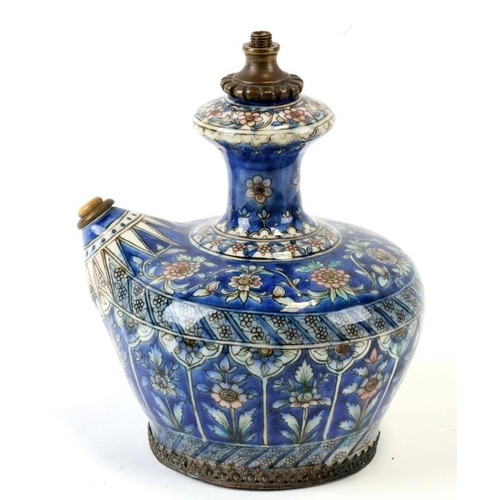 320 - A Persian pottery hookah base decorated with flowers on a blue ground, 21cms (8.25ins) high.