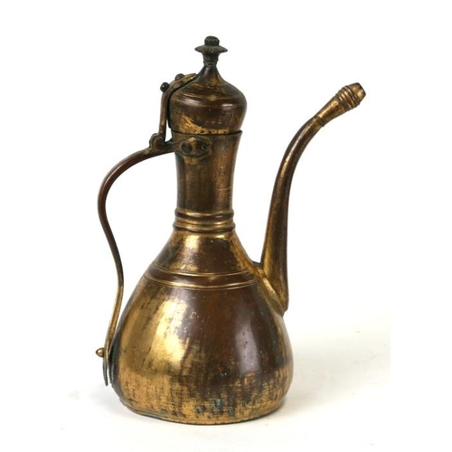 323 - A Turkish gilt copper coffee pot or ewer, 23cms (9ins) high.