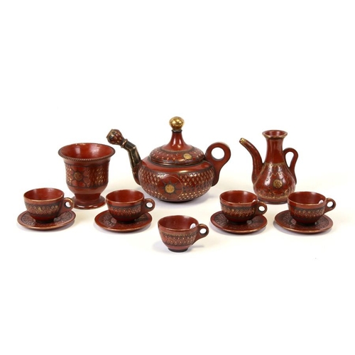 324 - A 19th century Turkish Tophane pottery part tea or coffee service with impressed gilded leaf and sun... 