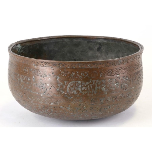 325 - An early Persian copper bowl decorated with foliate scrolls and script, 24cms (9.5ins) diameter.