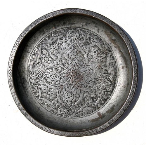 326 - An early Persian shallow dish decorated with flowers, 16.5cms (6.5ins) diameter.